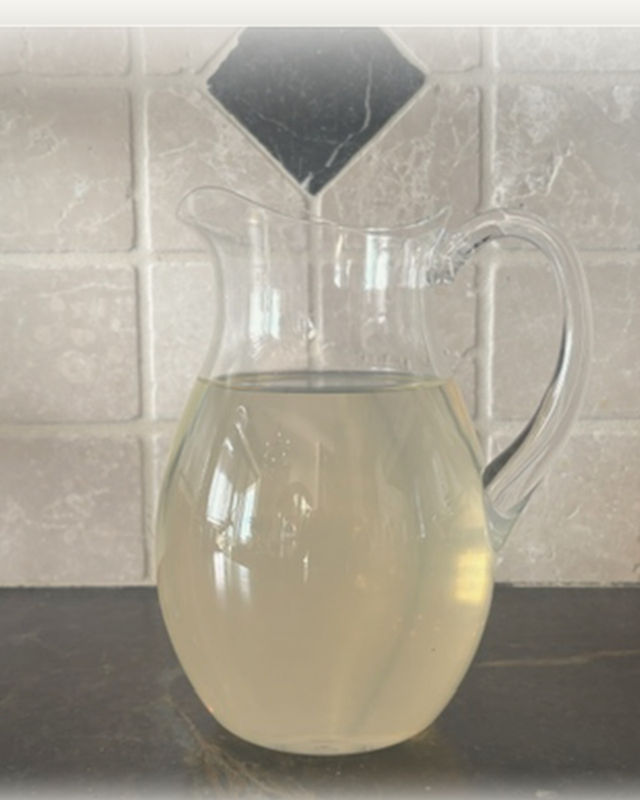 A pitcher of tap water on a kitchen counter.